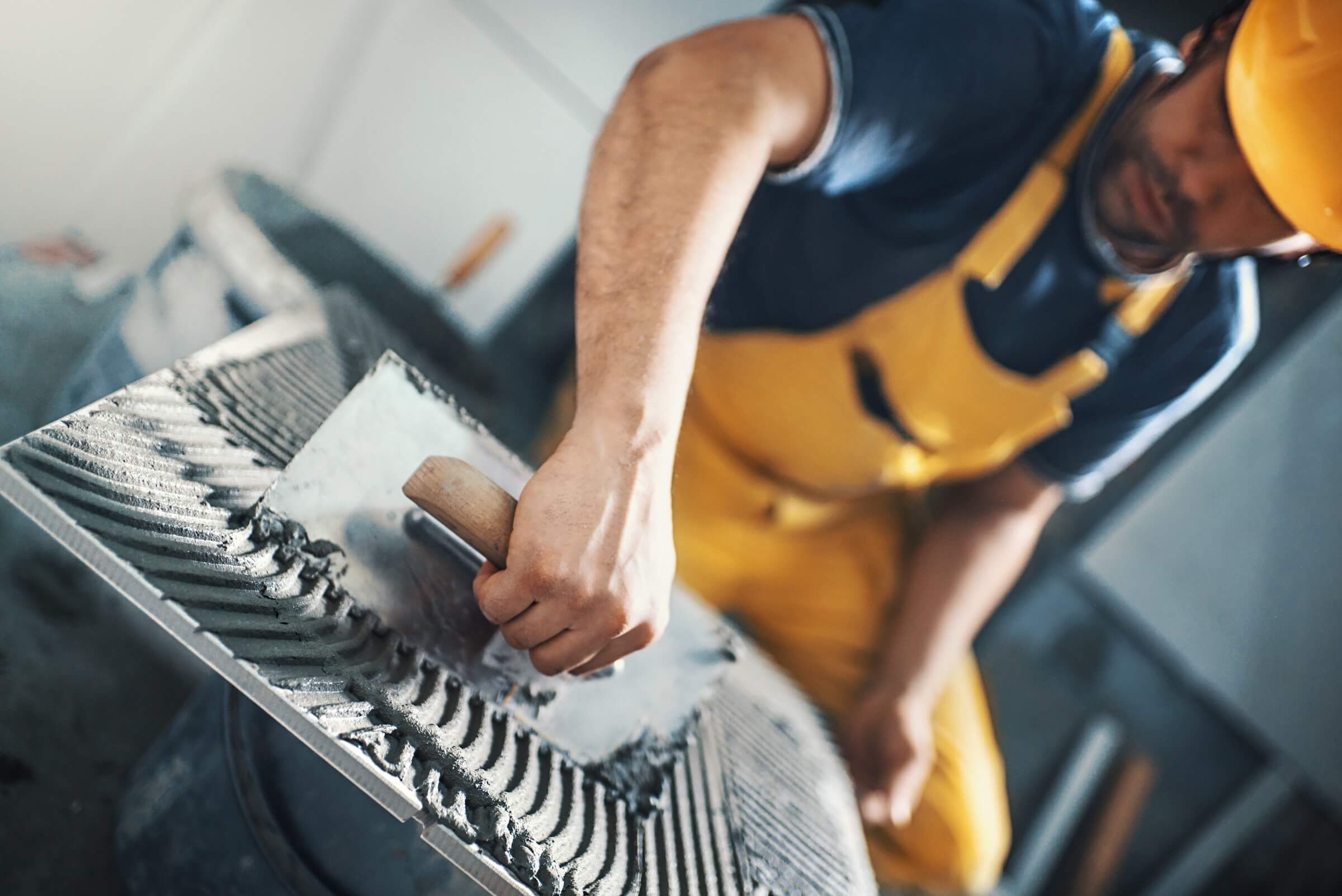A man preparing a concrete surface.