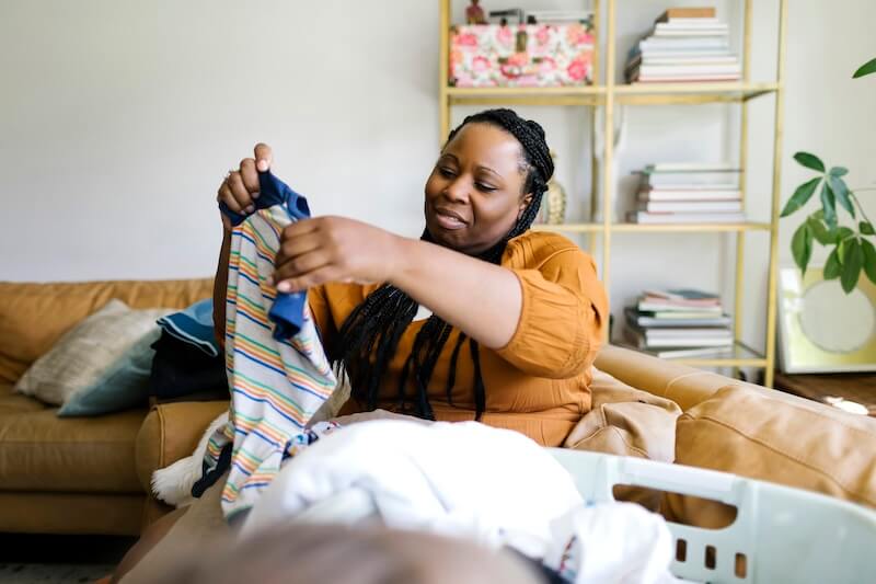 A woman folding clothes.